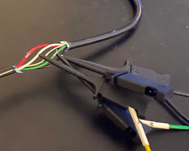 Logic analyzer probes connected to the internal wires of a USB cable